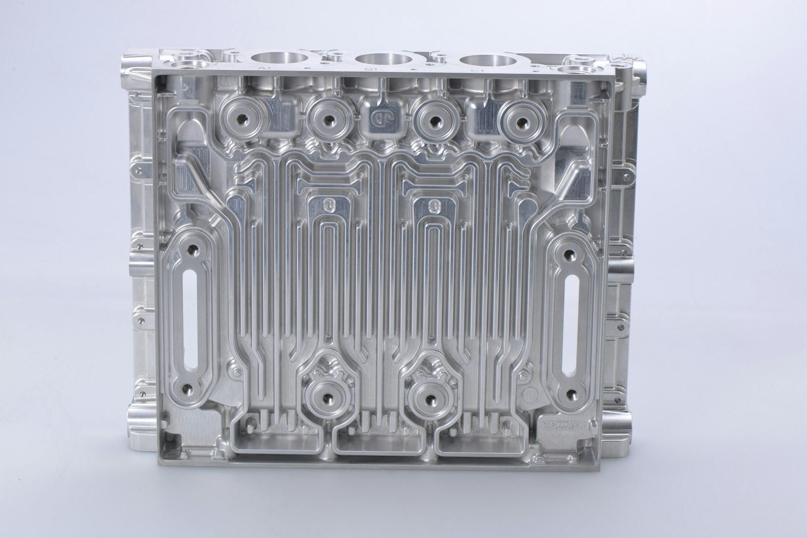 A precision-machined aluminum cylinder block with intricate cooling and oil channels